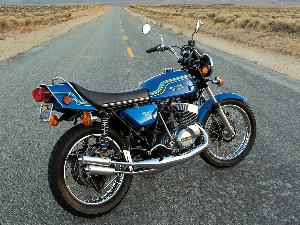 A 1972 kawasaki H2 MkIV motorcycle on a desert road at sunset in America